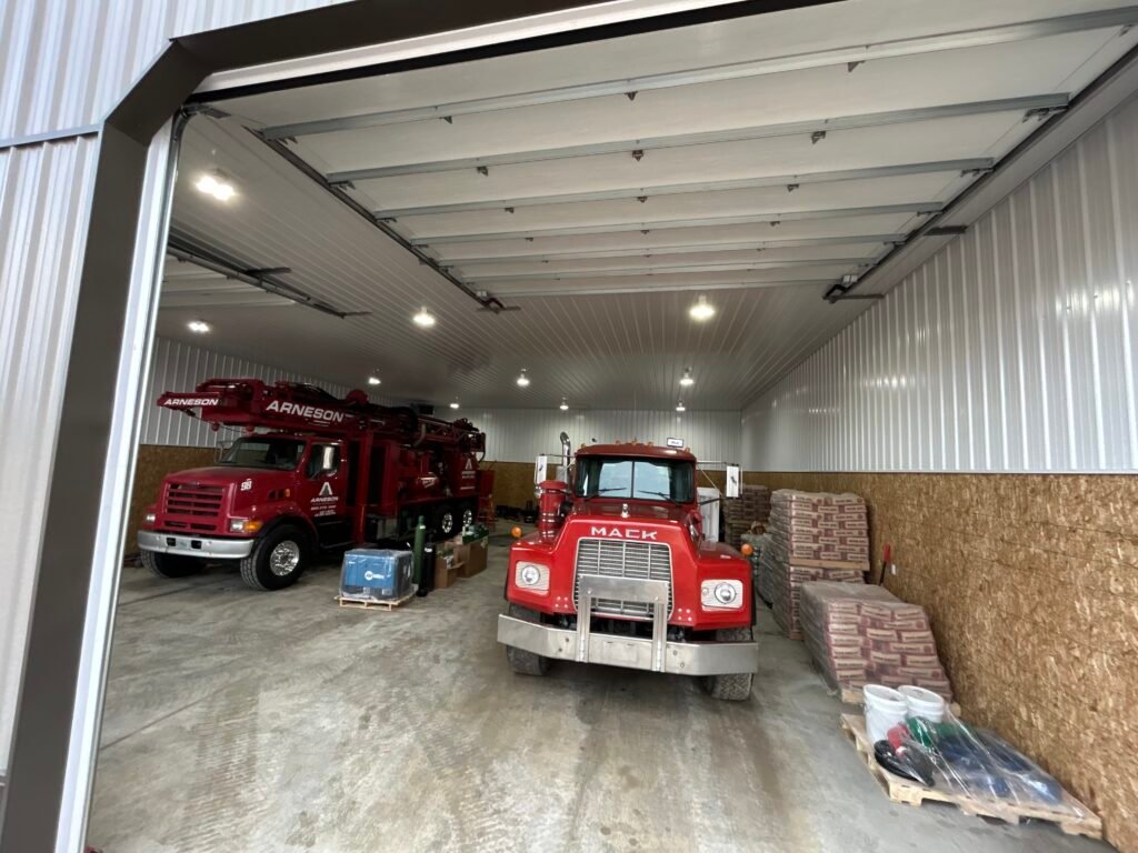 Arneson Well Drilling vehicles parked in a shop